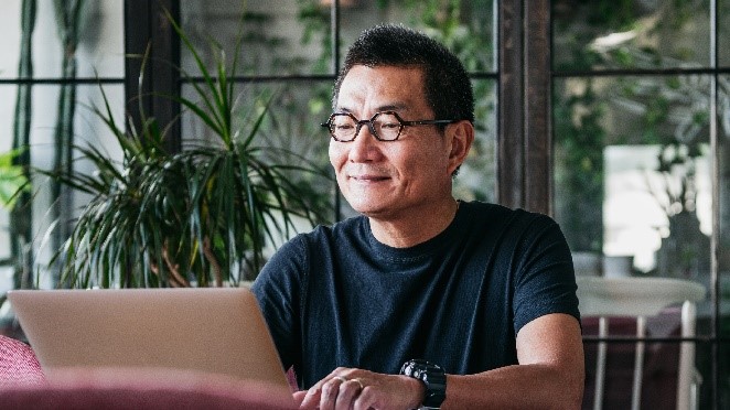A man looking at a laptop 